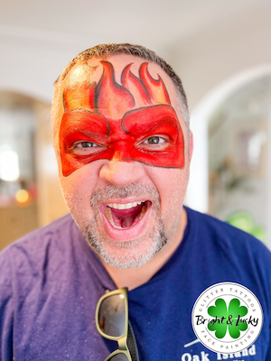 Smiling face with a custom face paint design: anger mask.