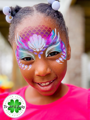 Smiling face with a custom face paint design: mermaid mask 3.