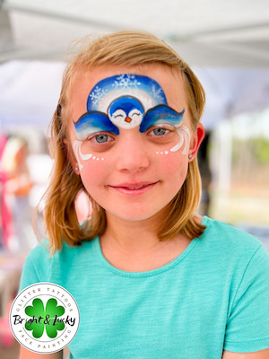 Smiling face with a custom face paint design: penguin mask.