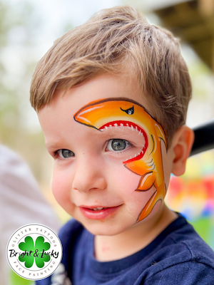 Smiling face with a custom face paint design: shark bite 2.