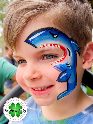 Smiling face with a custom face paint design: shark bite.