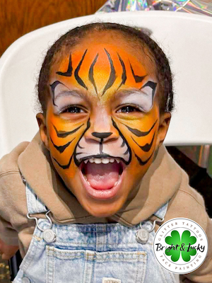 Smiling face with a custom face paint design: tiger face 2.