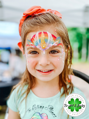 Smiling face with a custom face paint design: unicorn crown 3.