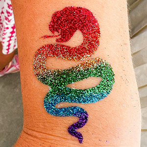 A glitter snake design with rainbow glitter, starting from to bottom with a red, gold, green, blue, and purple glitter gradient.